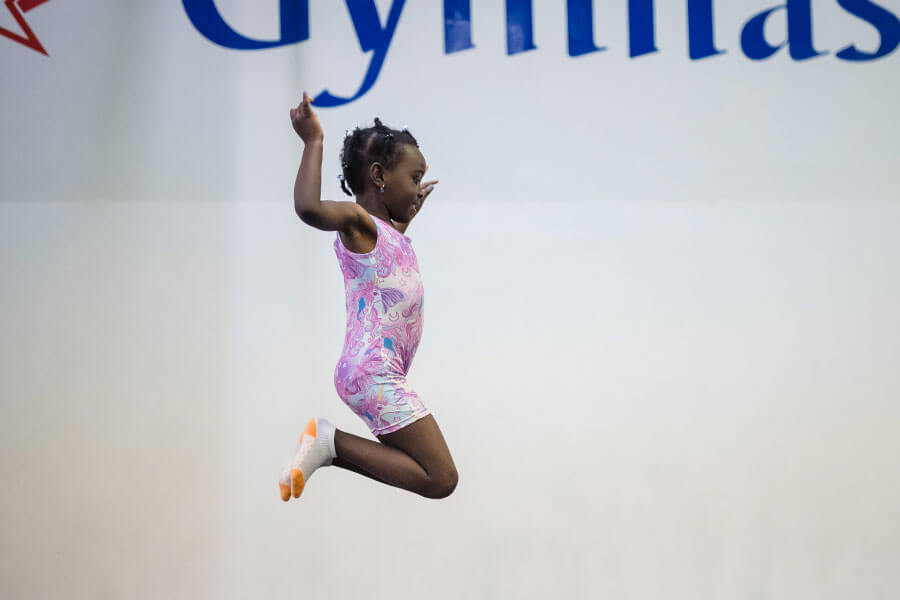 Young Black girl jumping in the air